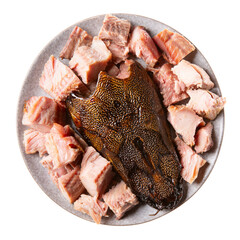 Hot smoked african catfish (Clarias gariepinus). Fish pieces on gray plate isolated on white background. Top view.