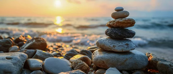 Poster Im Rahmen Against the backdrop of a serene sunset, harmonious stack of smooth pebbles of meditation and mindfulness, a symbol of balance and harmony with nature © Lidok_L