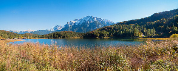 lake shore Lautersee with reed grass, Karwendel mountains, near Mittenwald