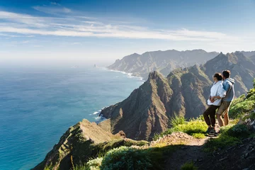 Fotobehang Canarische Eilanden Couple enjoying vacation in nature. Hikers watching beautiful coastal scenery.