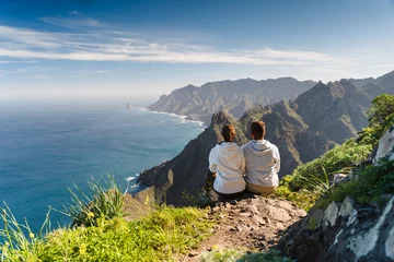 Papier Peint photo Lavable les îles Canaries Couple enjoying vacation in nature. Hikers watching beautiful coastal scenery.