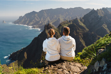 Couple enjoying vacation in nature. Hikers watching beautiful coastal scenery. - 768694452