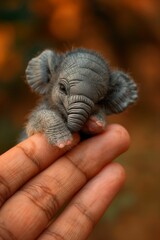 Miniature Baby Elephant on Human Hand, Magical Realism Concept