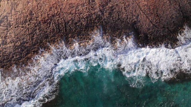 Aerial view drone of sea cost and waves. Sliding over the sea waves