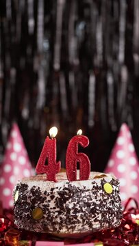 Burning candles numbers 46 on cake. Birthday cake for forty-sixth years old. Slow Motion. Copy space.