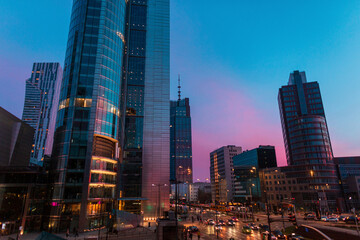 Beautiful modern city of Warsaw with buildings and road on the evening sunset sky with blue and...