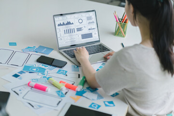 Creative ux ui designers team developing wireframe and sketching layout design mockup on smartphone...