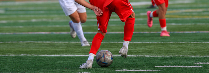 Soccer player dribbling the ball from behind