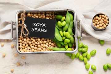 Soybeans on light cotton and wooden background. Vegan food concept.