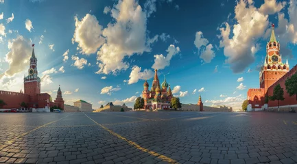 Fototapeten A panoramic view of the Moscow Red Square, showcasing St Basil's Cathedral and Sretenskymoskull tower, bathed in sunlight with blue sky above © Kien