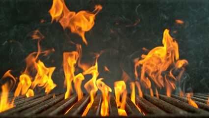 Close-up of cast-iron grate with fire flames, dark background - 768737271