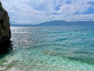 Rocky beach and crystal turquoise water of Ionian Sea in Albania.