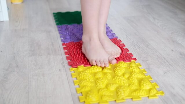 Children's feet on an orthopedic mat. Prevention of childhood diseases.	