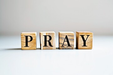 Obraz premium PRAY text on the wooden block, wooden cubes on white background with copy space, religion concept space for text