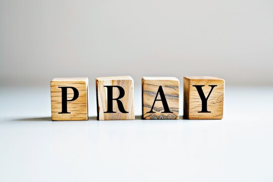 PRAY text on the wooden block, wooden cubes on white background with copy space, religion concept space for text