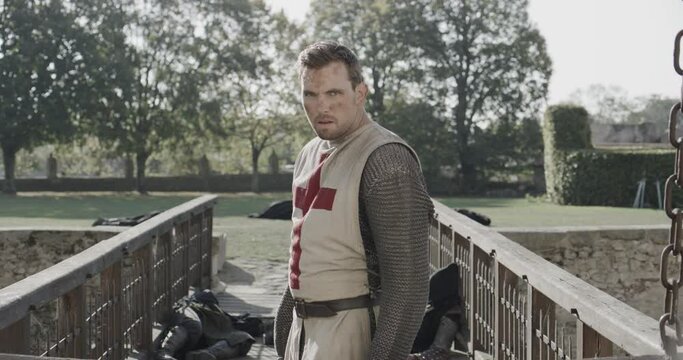 Epic reveal of knight as draw bridge lowers - steady cam, medium shot