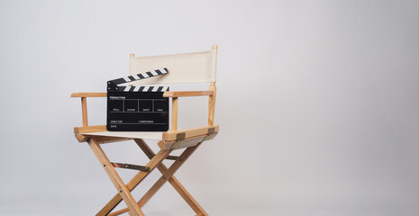 Director chair in ivory color and clapper board on white background