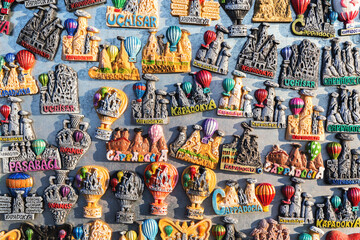 Assorted Cappadocia magnets with vibrant balloons and fairy chimneys in warm earth tones. Uchisar,...