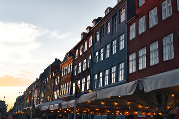 Copenhagen, Denmark - August 30, 2021. Famous Nyhavn pier with colorful buildings and boats in...