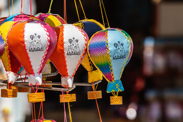 Colorful Cappadocia hot air balloon souvenirs in rainbow hues, dangling with 'Turkey' tags....