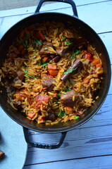 lamb stewed with tomatoes and orzo, background of greek traditional food youvetsi