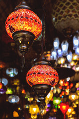 A fiery red Turkish mosaic lamp emits a warm, ambient glow. Atmospheric lighting in home decor....