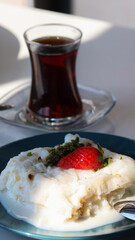 Ramadan Dessert Gullac Close-Up Shot on Table with turkish tea
This captivating close-up shot showcases a delectable serving of Gullac, a traditional Turkish dessert typically enjoyed during Ramadan. 