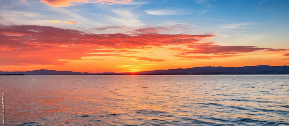 Poster a serene view of a colorful sunset over the ocean, with a small boat gently floating in the water, c
