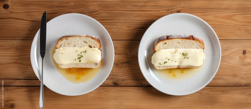 Aufkleber Two plates with slices of bread and butter are neatly arranged on a wooden table, creating a simple and appetizing display