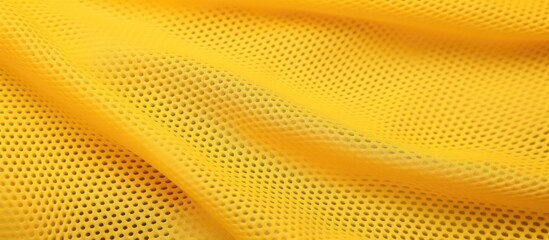 Yellow mesh sportswear fabric textile pattern background with a subtle design in a vibrant yellow...