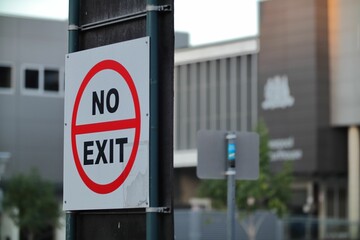No-exit sign taped to a metal pole