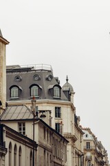 Old-fashioned Parisian building facade during the daytime displaying the beauty of the city