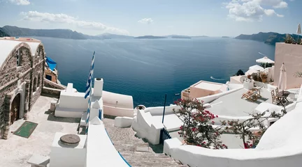 Fotobehang Aegean Sea with traditional white buildings on the shore. Oia, Santorini, Greece. © Wirestock