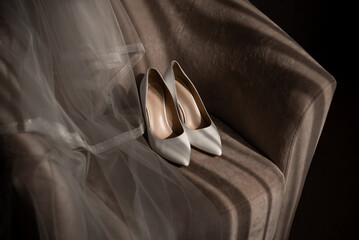 Bride's shoes and veil on a chair	
