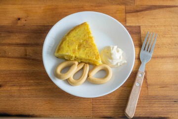 Top view of a fresh potato pancake with eggs and dip on the table