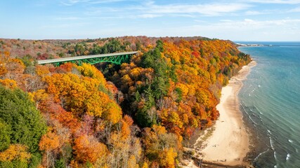 Aerial view of the Cut River Bridge in Michigan, surrounded by vibrant fall colors of the forests
