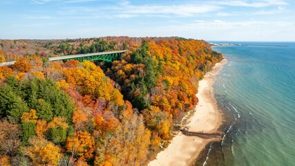 Aerial view of the Cut River Bridge in Michigan, surrounded by vibrant fall colors of the forests