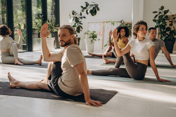 Diverse sporty people having yoga practice with instructor - 768799269