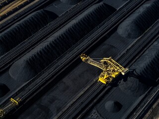 a large machine is on top of some tracks with coal
