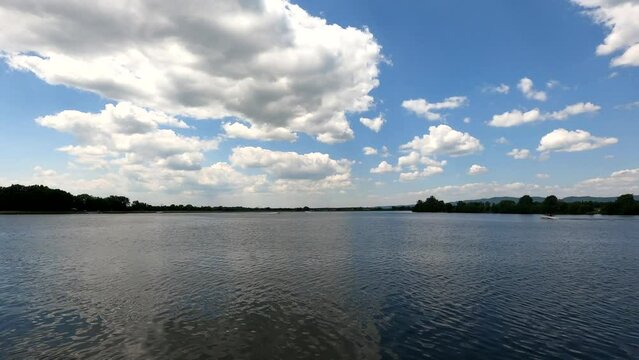 Timelapse of a lake with blue cloudy sky