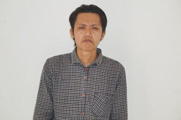 Obraz premium Portrait of young Asian man wearing a black shirt looking sad expression