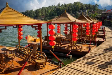 Foto op Canvas Beautiful views of hills, Chinese buildings and ancient boats in the lake serve tourists at Baan Rak Thai Chinese characters on red lanterns- translated text means port, happiness, good luck,wealth © nopporn
