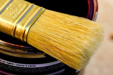 Closeup shot of a clean paintbrush on a can of paint