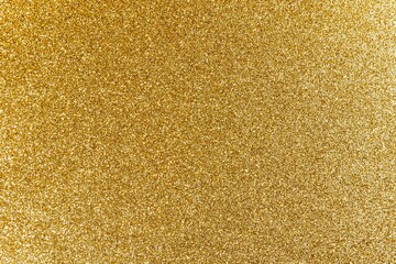 a bright, shiny gold glitter texture with slight highlights on the edges - obrazy, fototapety, plakaty