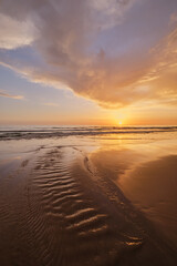 Atlantic ocean sunset with surging waves at Fonte da Telha beach, Costa da Caparica, Portugal - 768810859