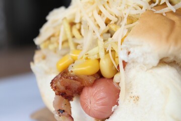 Closeup of a delicious hot dog stuffed with corns and cheese