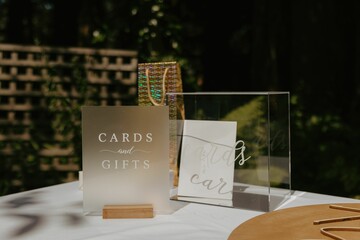 Vibrant display of cards and gifts laid out on a wooden table for a wedding ceremony