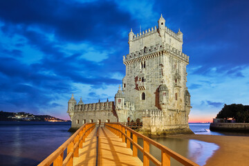 Belem Tower or Tower of St Vincent - famous tourist landmark of Lisboa and tourism attraction - on the bank of the Tagus River (Tejo) after sunset in dusk twilight with dramatic sky. Lisbon, Portugal - 768814074