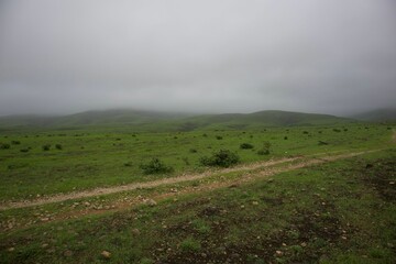 Stunning landscape featuring lush green field during cloudy weather