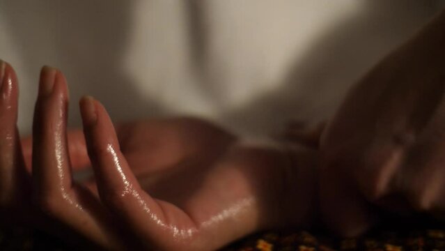 Slow motion of a closeup of hand oil massage.